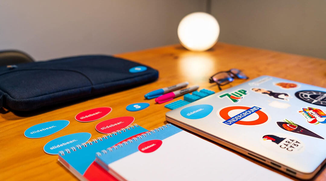 An image of a laptop and a couple of stationery products on the table